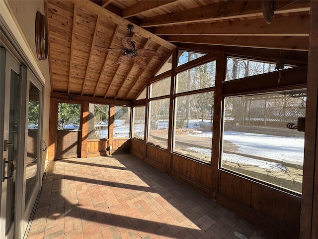 unfurnished sunroom with ceiling fan, wooden ceiling, and vaulted ceiling with beams