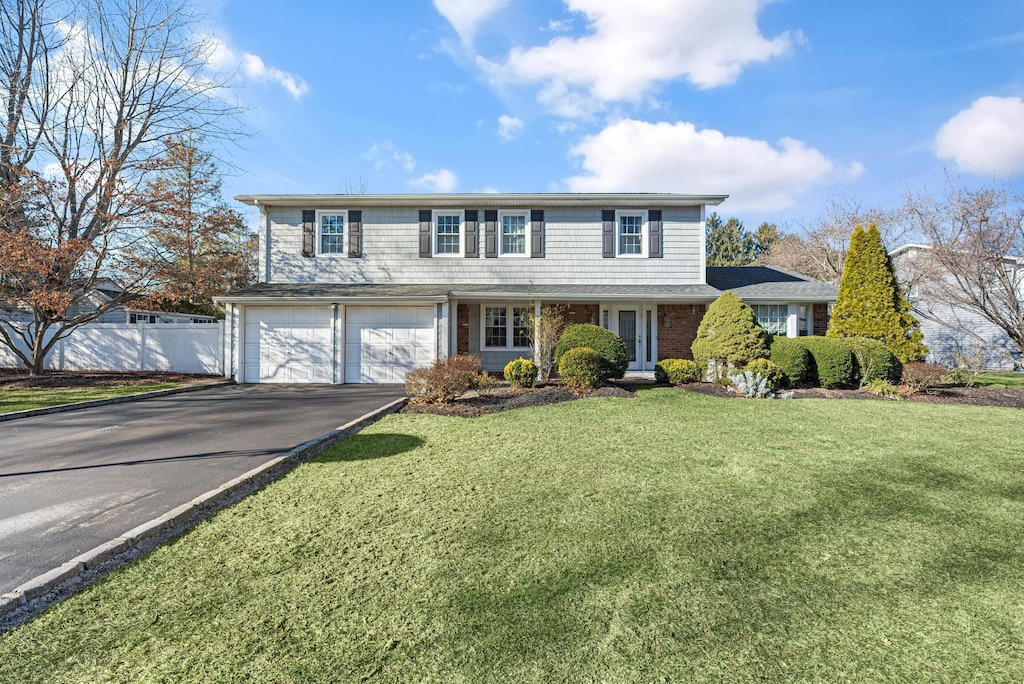 view of property with a front yard and a garage