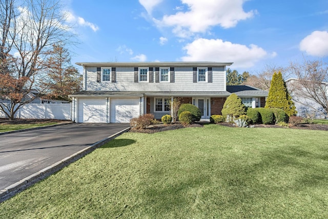 view of property with a front yard and a garage