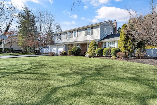 view of front property featuring a front yard and a garage