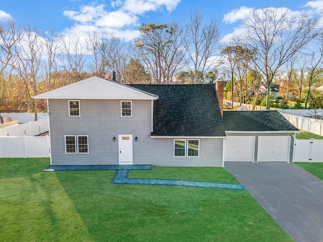 view of front of property featuring a garage and a front yard