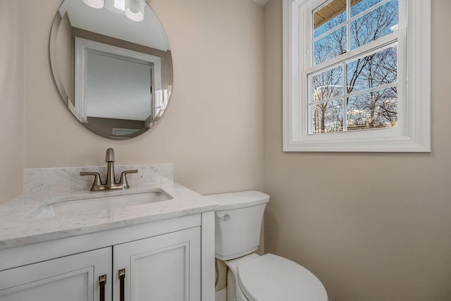 bathroom with toilet and vanity