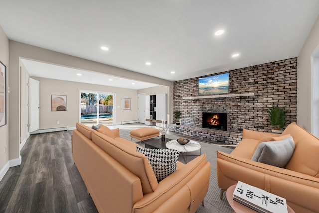 living room featuring a brick fireplace, hardwood / wood-style floors, and a baseboard radiator