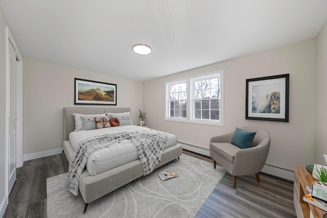 bedroom featuring a baseboard radiator and dark hardwood / wood-style floors