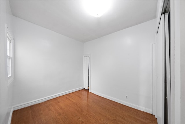 unfurnished room with wood-type flooring