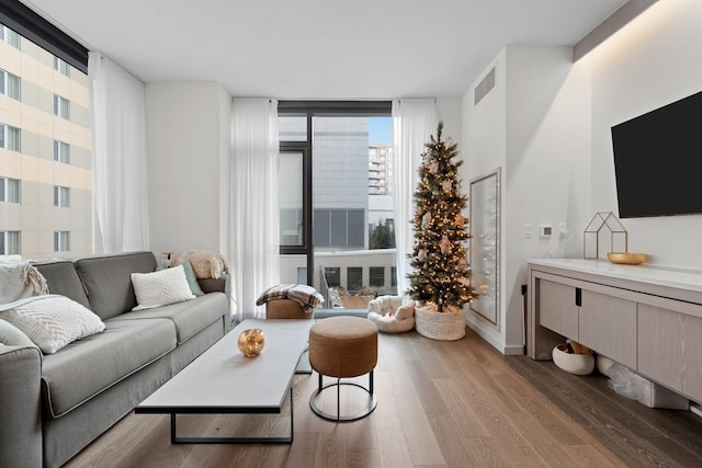 living room with expansive windows and hardwood / wood-style floors