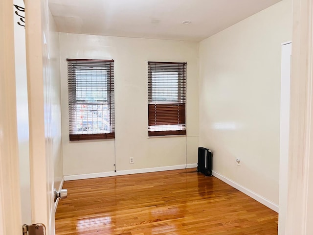 unfurnished room with wood-type flooring