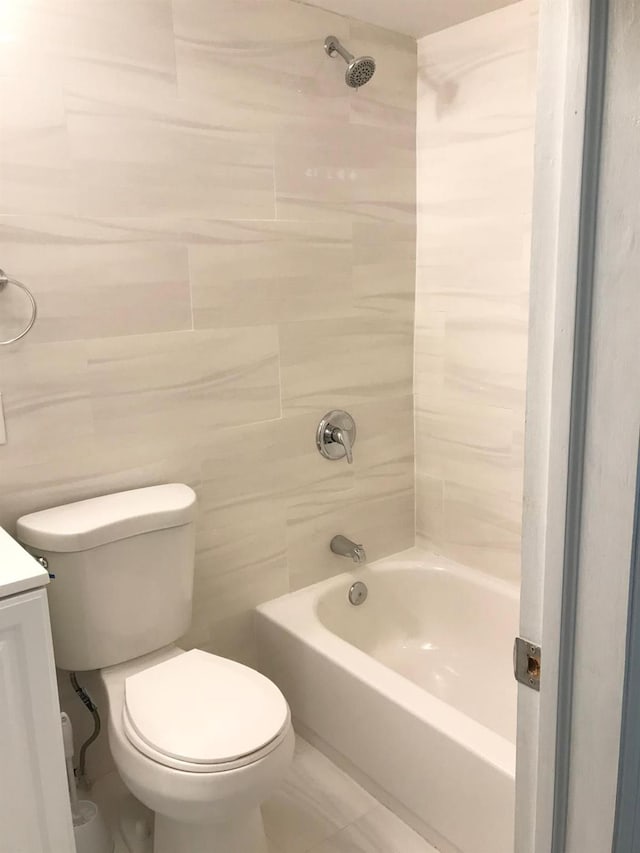 full bathroom featuring vanity, toilet, and tiled shower / bath combo