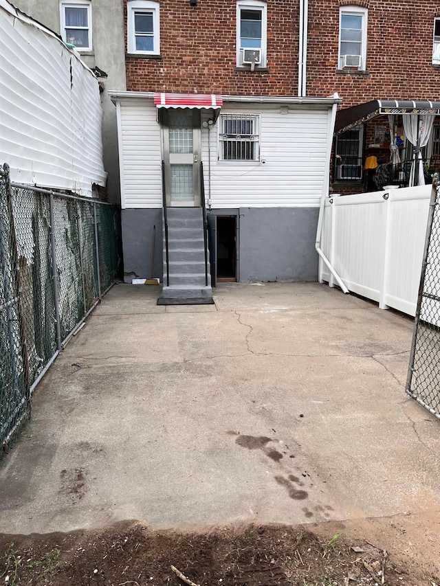 rear view of property with a patio area and cooling unit