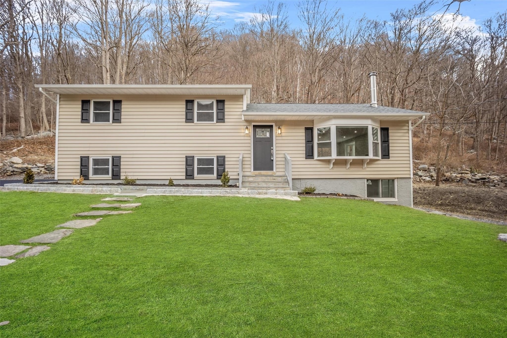 tri-level home with a front yard