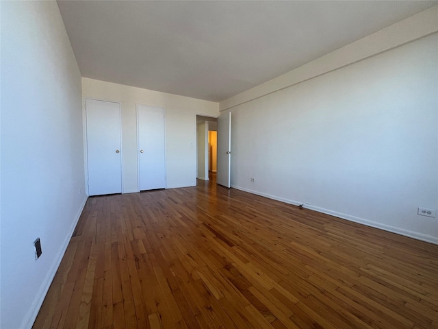 unfurnished bedroom featuring dark wood-type flooring