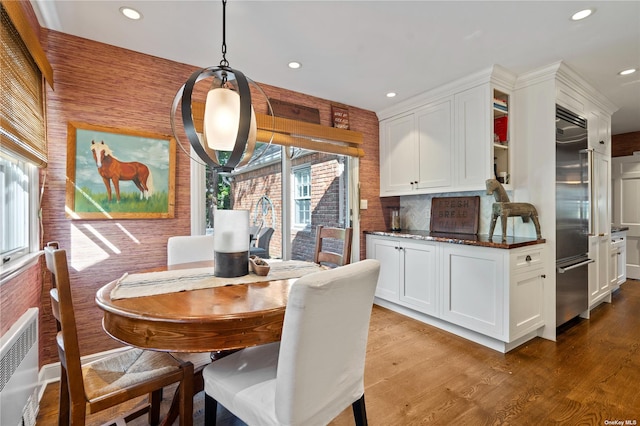 dining room featuring radiator and light hardwood / wood-style flooring