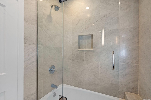 bathroom featuring shower / bath combination with glass door