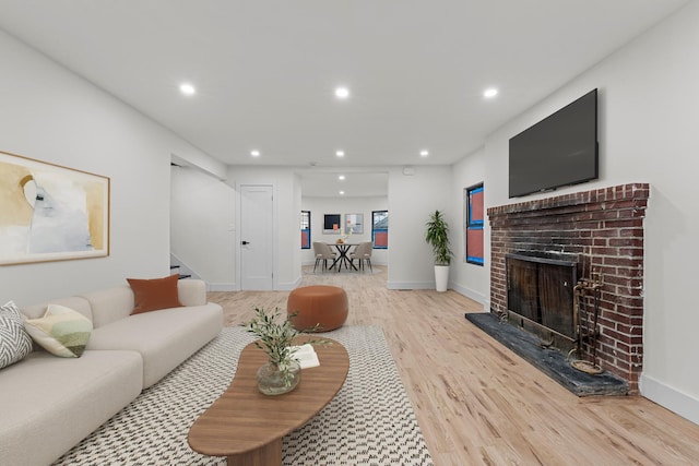 living room with light hardwood / wood-style floors and a fireplace