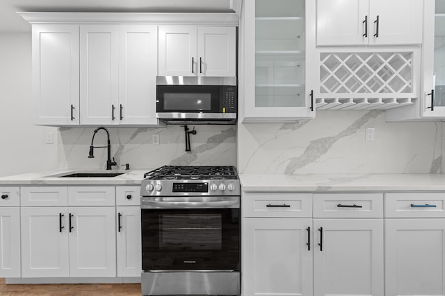 kitchen with sink, white cabinetry, and stainless steel appliances