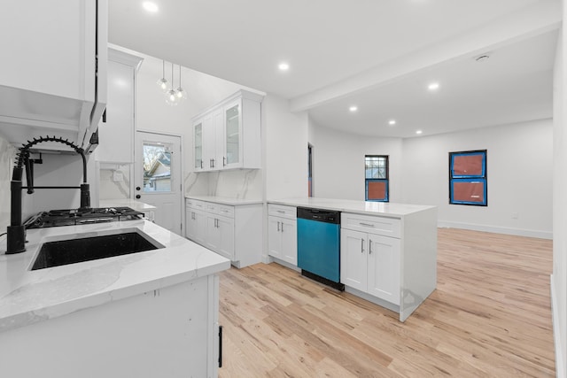 kitchen featuring white cabinetry, light stone counters, stainless steel dishwasher, kitchen peninsula, and light hardwood / wood-style floors