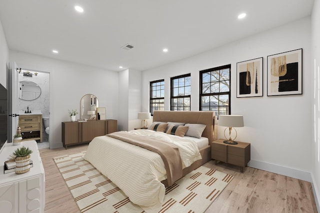 bedroom featuring sink and light wood-type flooring