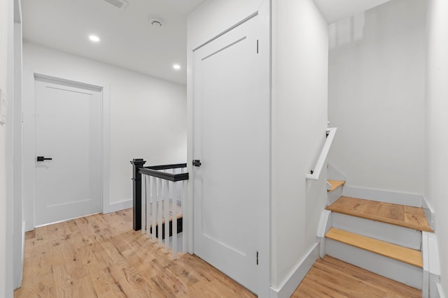 staircase featuring hardwood / wood-style flooring