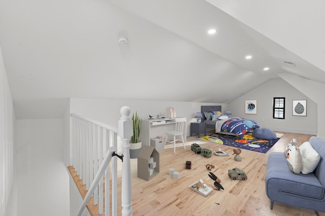 bedroom featuring wood-type flooring and vaulted ceiling