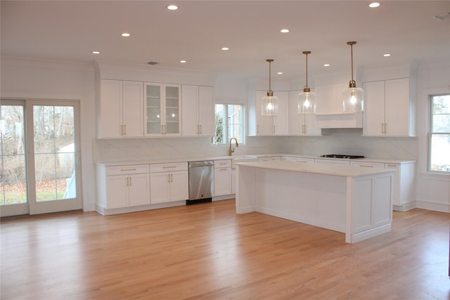 kitchen featuring plenty of natural light, dishwasher, and white cabinetry