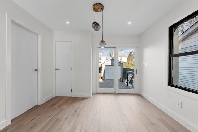 unfurnished room with light hardwood / wood-style floors