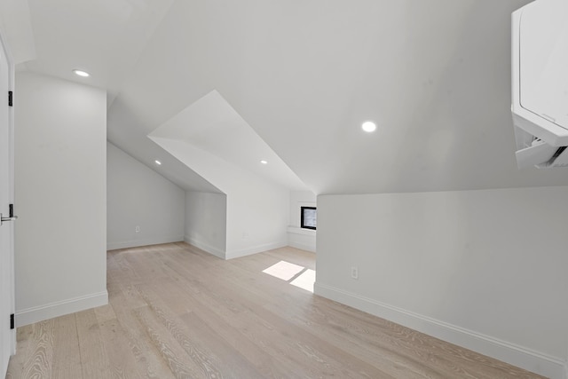 bonus room featuring lofted ceiling and light wood-type flooring