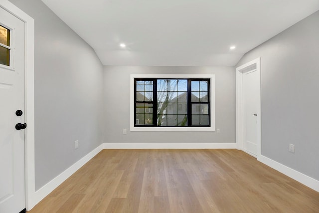 interior space with lofted ceiling and light wood-type flooring