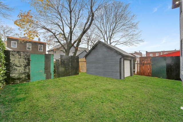 view of yard with a garage and an outdoor structure