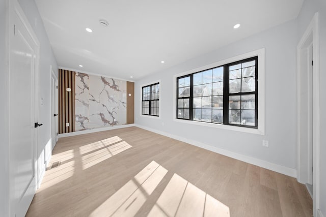 empty room with light hardwood / wood-style flooring