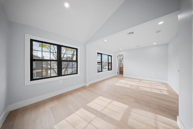 empty room featuring lofted ceiling and light wood-type flooring