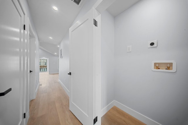 corridor with light hardwood / wood-style floors