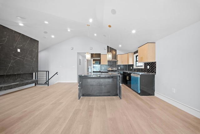 kitchen featuring light brown cabinetry, decorative light fixtures, dishwasher, a center island, and wall chimney range hood