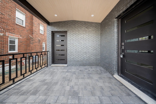 view of exterior entry with a balcony