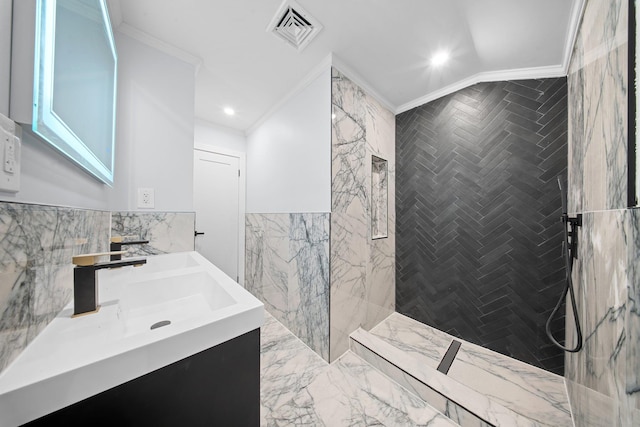 bathroom featuring tile walls, vanity, crown molding, and tiled shower