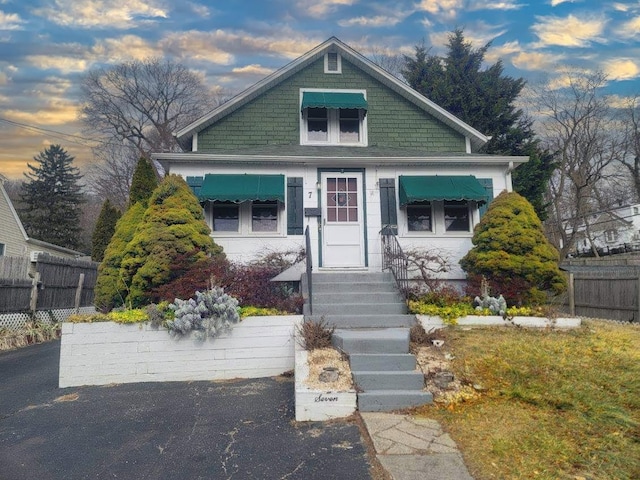 view of front of home featuring fence