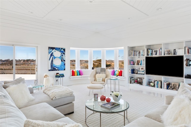 living room with built in shelves and wooden ceiling