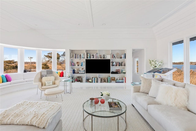 living room featuring built in features, wood ceiling, and a towering ceiling