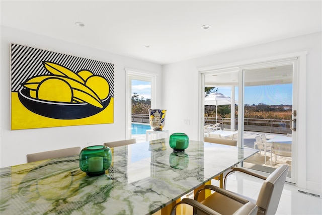 dining space featuring light tile patterned flooring