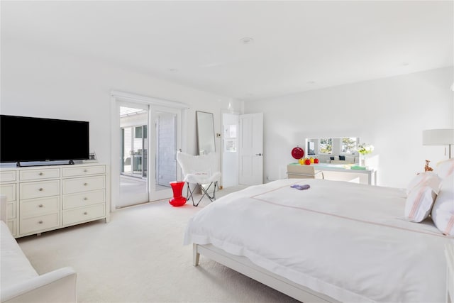 carpeted bedroom featuring access to exterior and multiple windows