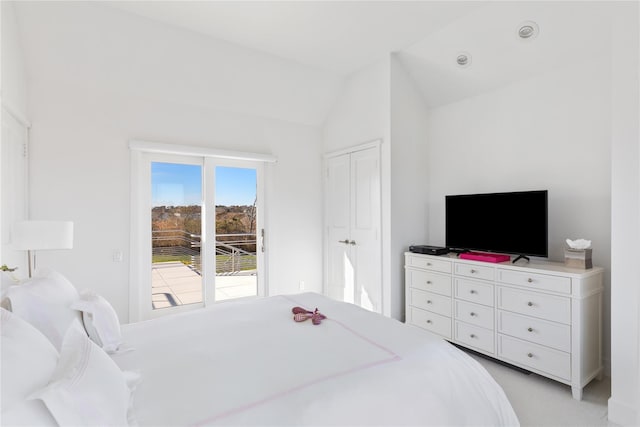 bedroom with light carpet and vaulted ceiling