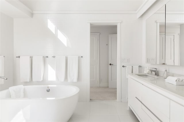 bathroom featuring tile patterned floors, vanity, and a bath