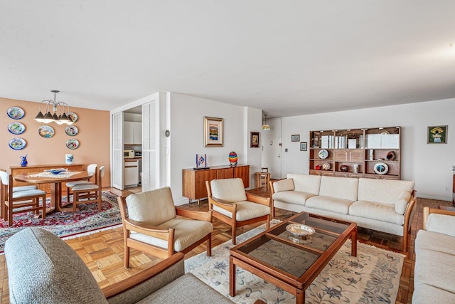 living room featuring parquet flooring and a notable chandelier