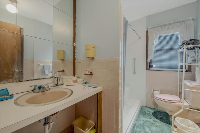 bathroom featuring sink, tile walls, and walk in shower