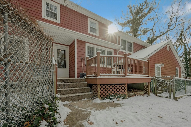 view of snow covered back of property