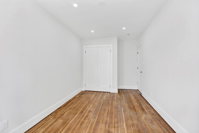 unfurnished room with hardwood / wood-style flooring