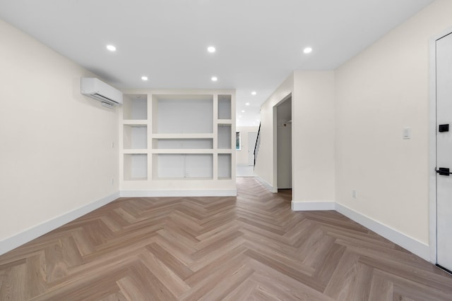 interior space featuring built in features, light parquet floors, and an AC wall unit