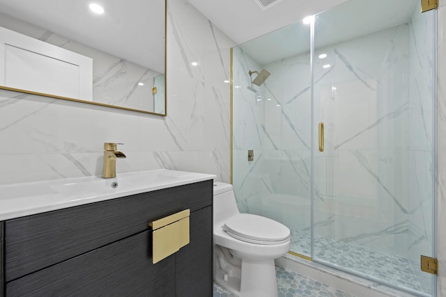 bathroom featuring tile patterned flooring, vanity, toilet, and a shower with door