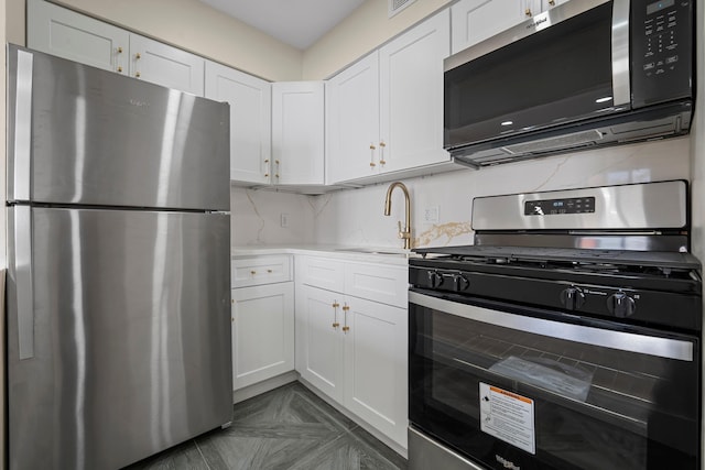 kitchen featuring white cabinets, backsplash, sink, and stainless steel appliances