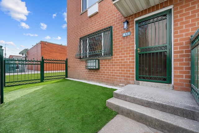 doorway to property featuring a lawn