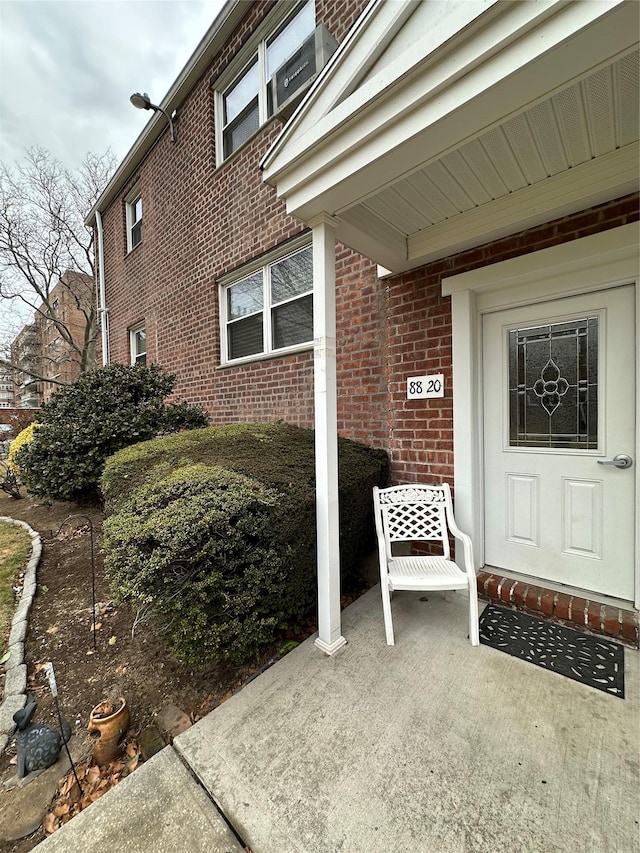 view of exterior entry featuring a patio